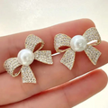 Crystal-Encrusted Bow Studs – Classic Pearl & Gold Design