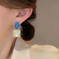 Ocean Ripple Dual-Tone Enamel Earrings – Elegant Blue & Ivory Studs with Gold Trim